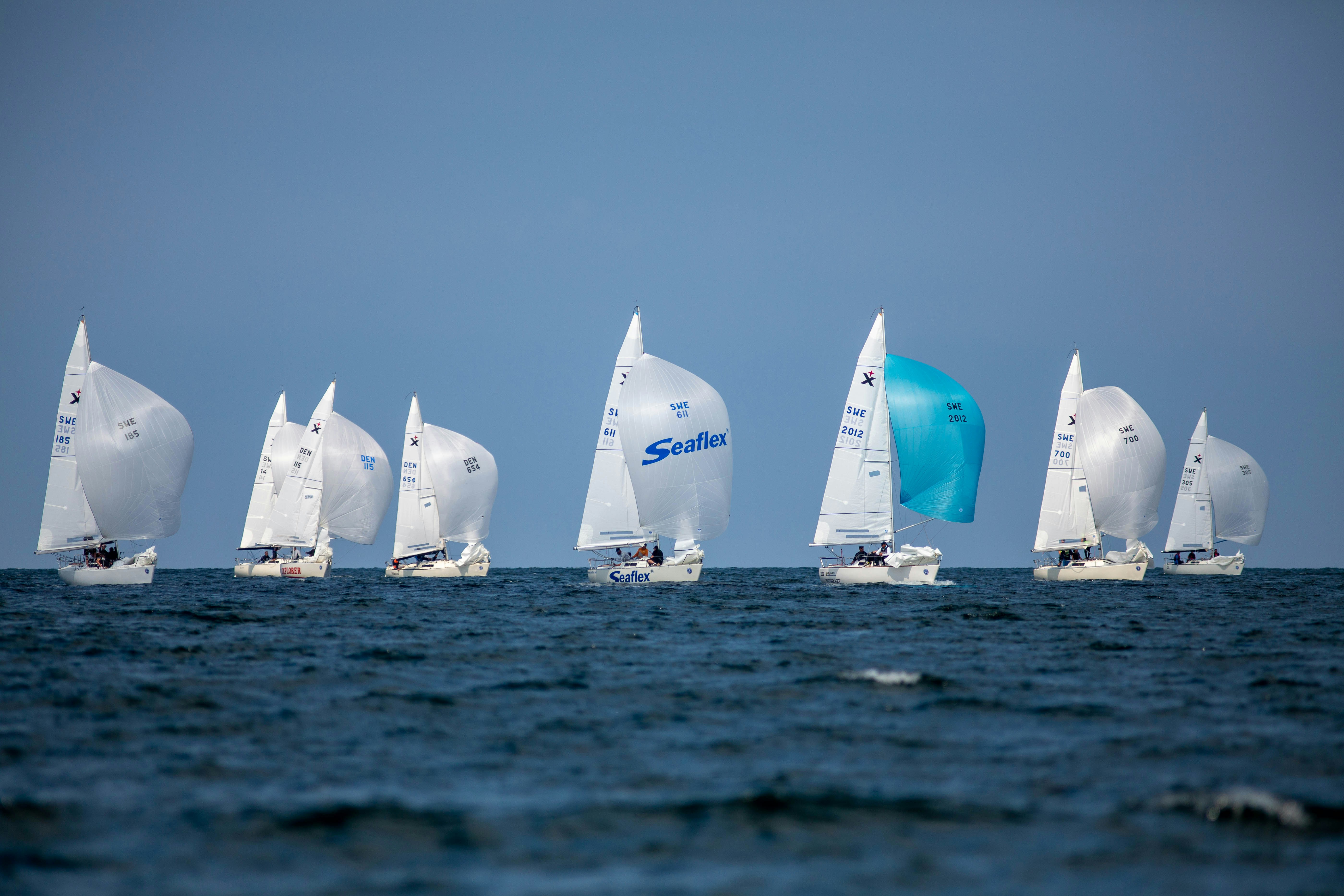 Dynamic shot of sailing boats racing with splashes